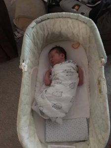 baby rolling over in bassinet