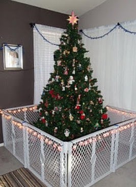 Christmas tree surrounded by a baby safety gate for childproofing