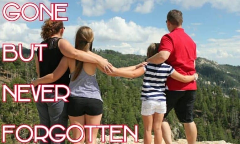 Family standing together overlooking mountains, honoring a loved one gone but never forgotten